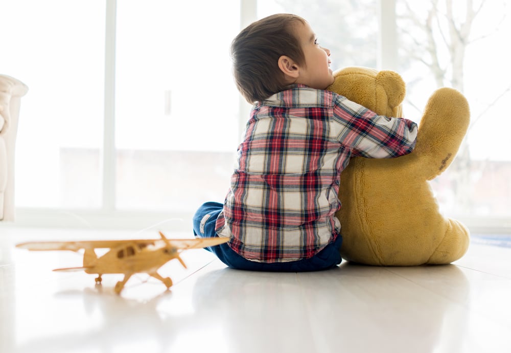 Portrait of child sitting in living room with Teddy bear-1